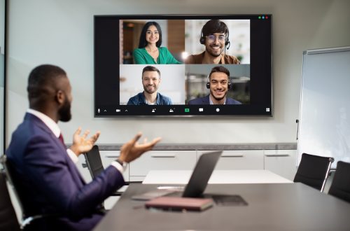 African american businessman having video conference with multiracial team employees, looking at digital display, talking, gesturing. Colllage for modern technologies and business concept